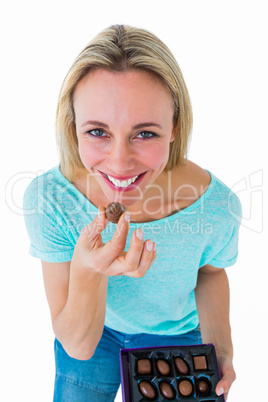 Smiling blonde holding box of chocolates