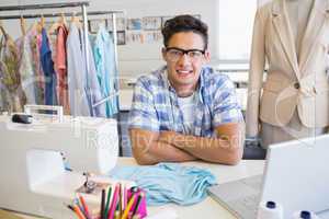 College student sitting with sewing machine and laptop