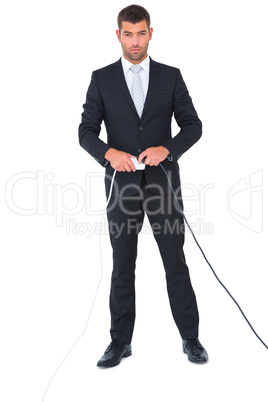 Serious businessman connecting a plug