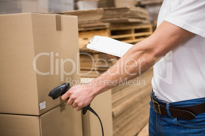 Worker using scanner in warehouse
