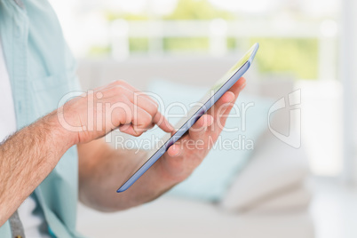 Casual businessman using tablet at desk