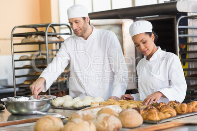 Team of bakers preparing dough and pastry