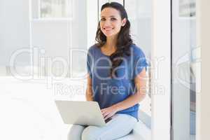 Pretty brunette using her laptop