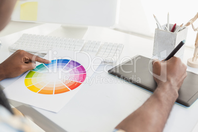 Businessman using colour sample and digitizer