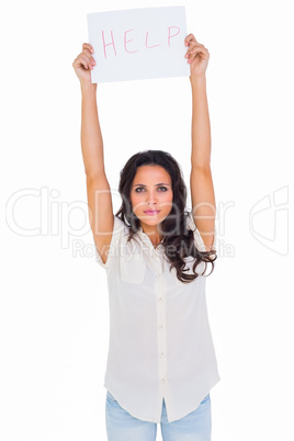 Brunette holding up help sign