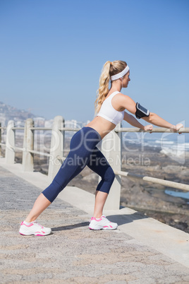 Fit blonde listening to music warming up