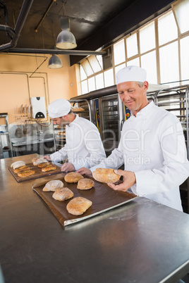 Bakers checking freshly baked bread