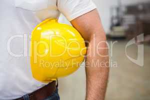 Close up of warehouse worker holding a hard hat