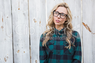 Unsmiling blonde standing and thinking