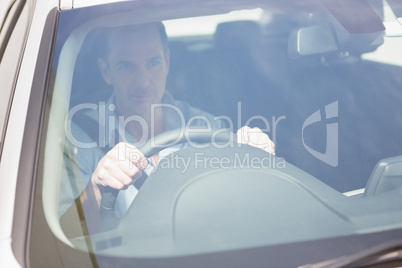 Focused man sitting at the wheel