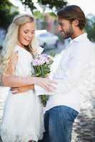 Attractive couple with bunch of flowers