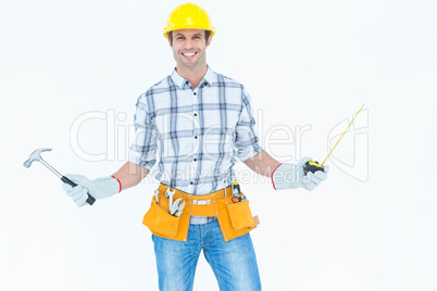 Technician holding hammer and measure tape