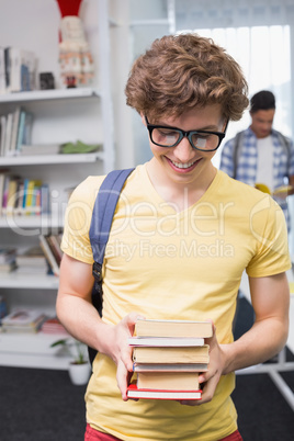 Students carrying small pile of books