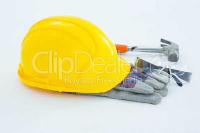 Protective gloves with hammer, glasses and yellow hard hat