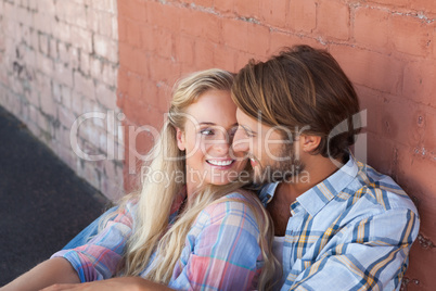 Cute couple sitting on ground