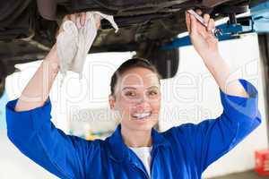 Mechanic examining under the car