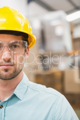 Close up of worker wearing hard hat in warehouse