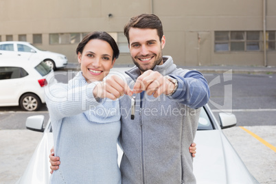 Young couple smiling holding new key