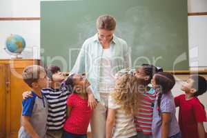 Cute pupils smiling at camera in classroom