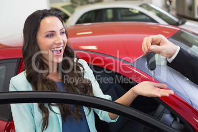 Excited woman receiving car key