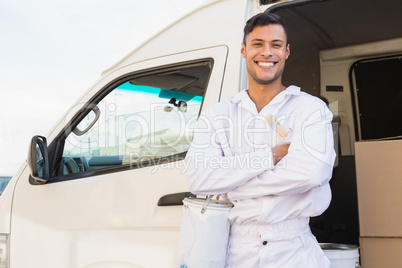 Painter smiling leaning against his van