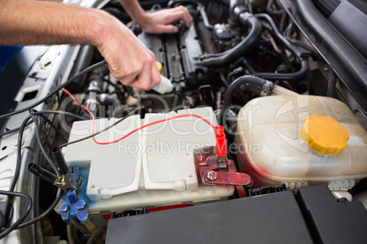 Mechanic working under the hood Mechanic working under the hood
