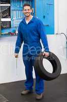 Mechanic holding a tire wheel