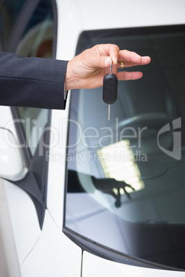 Close up of businessman holding car key