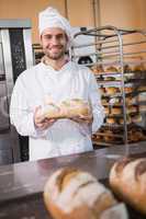 Baker holding freshly baked bread
