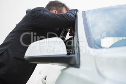Businessman looking inside the car