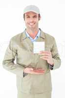 Happy delivery man showing blank note