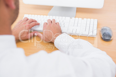 Businessman typing on computer keyboard