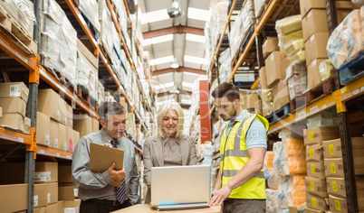 Warehouse team working together on laptop