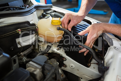 Mechanic working under the hood