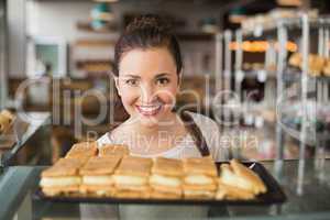 Pretty brunette looking at pastrys