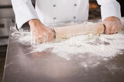 Close up of baker using a rolling pin