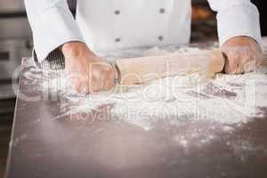 Close up of baker using a rolling pin