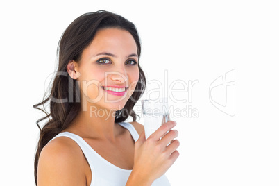 Pretty brunette drinking glass of water