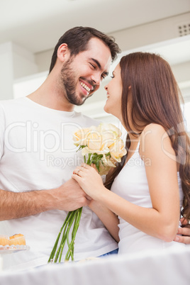 Young man giving girlfriend white roses