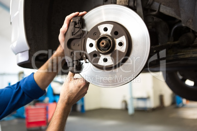 Focused mechanic adjusting the wheel