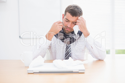 Stressed businessman looking down