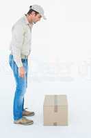 Delivery man looking at cardboard box