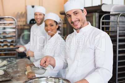 Team of bakers smiling at camera