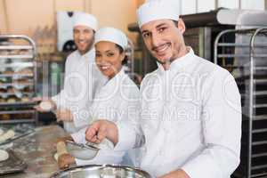 Team of bakers smiling at camera