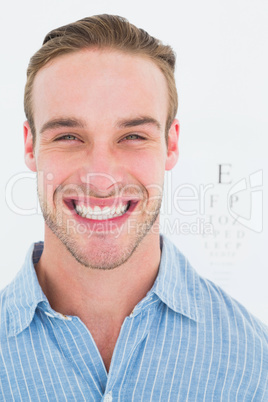 Happy handsome in shirt in front of eye test