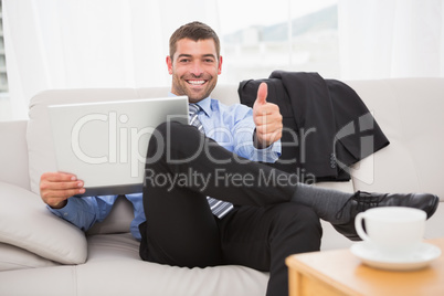 Relaxing businessman on a sofa with a laptop