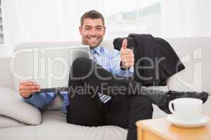 Relaxing businessman on a sofa with a laptop