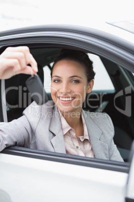 Young woman smiling and holding key