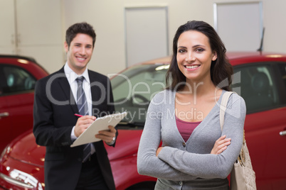 Smiling businessman undersign a car contract