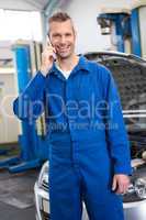 Smiling mechanic on the phone